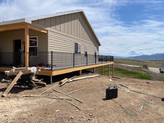 Advanced Custom Builders custom home under construction near Missoula with board-and-batten siding and mountain views